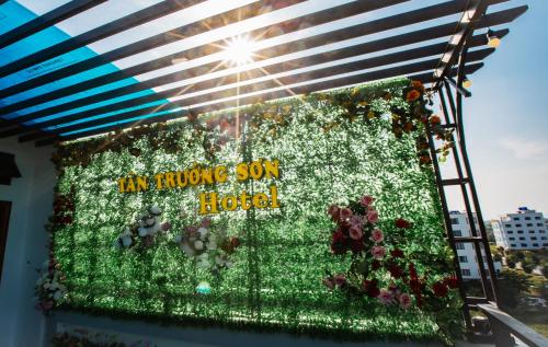 a sign for a flower garden on a building at Tan Truong Son Legacy Hotel in Sầm Sơn