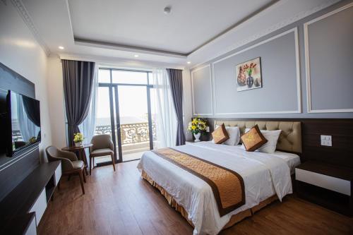 a hotel room with a bed and a television at Tan Truong Son Legacy Hotel in Sầm Sơn
