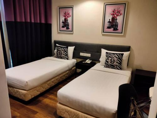 a hotel room with two beds in a room at 9 Square Hotel - Subang in Subang Jaya