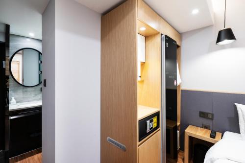 a room with a door leading into a bedroom at LALA VIANCO BUSINESS Hotel in Busan