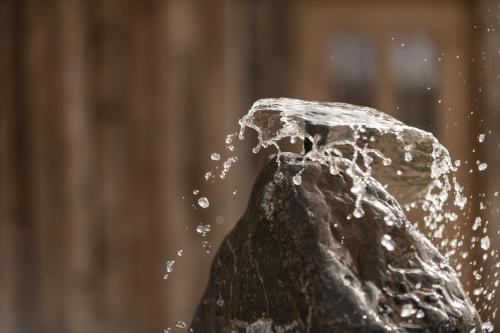 a water fountain spewing water onto a rock at Hüttendorf Ladizium in Ladis