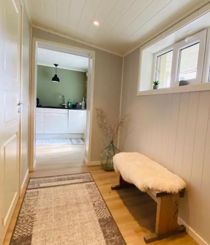 a living room with a bench and a sink at Villa Lovise Riverside in Stranda