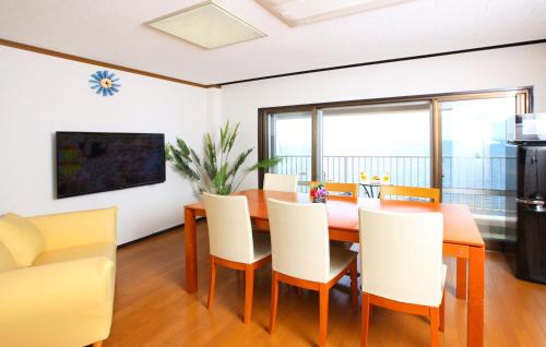 a dining room with a table and chairs at Shirahama Beach 312 in Shirahama