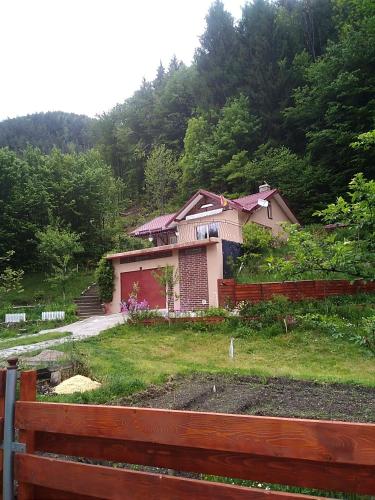 a house on top of a hill with a fence at Casa Ozon in Vulcan