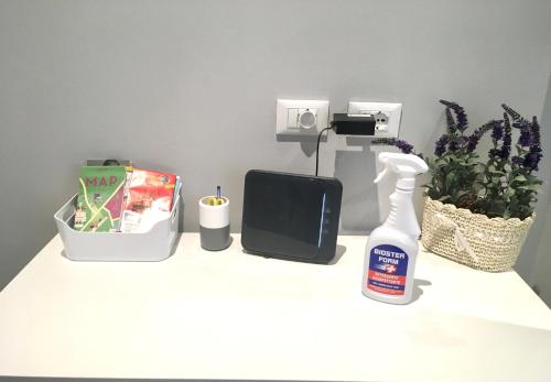 a white table with a hair dryer and a bottle on it at MONOLOCALE VICINO MILANO1 in Lodi