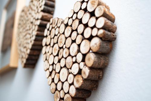 a wall with a bunch of wood rounds on it at Hotel Stadt Freiburg in Freiburg im Breisgau