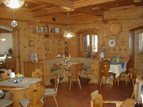 a dining room with tables and chairs in a cabin at Gasthof-Metzgerei-Pension Schierlitz in Rimbach