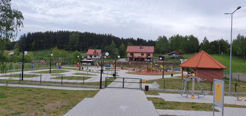 a park with a playground and a play area at Domek Kruklanki in Kruklanki