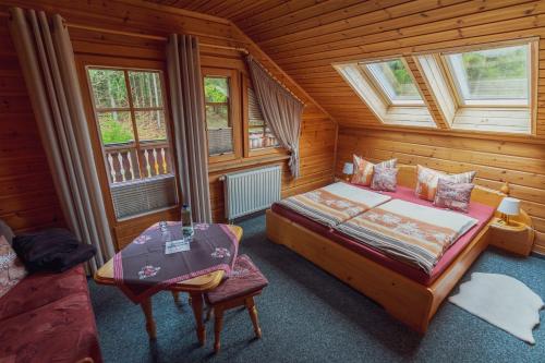 a bedroom with a bed and two windows at Gaststätte und Pension Zum Torfstich in Hundshübel
