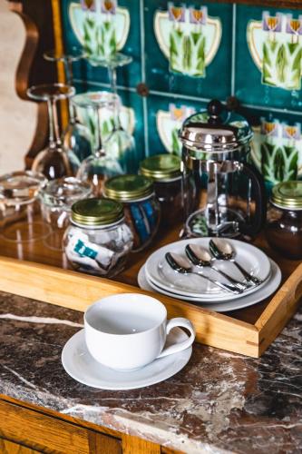 a table with a coffee cup and plates on it at Ravenswood Homestead in Ravenswood