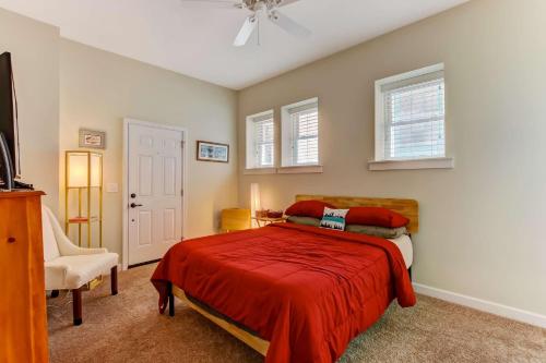 a bedroom with a bed with a red blanket at JBH 115 W 2nd Apt #2 in Jacksonville