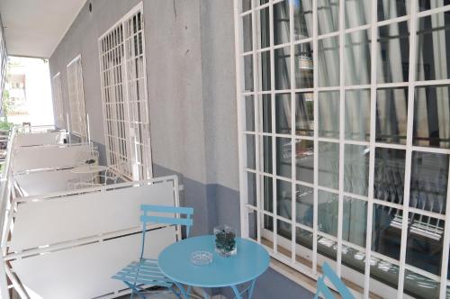 a table and chairs in a room with windows at Sweet Home Parioli in Rome
