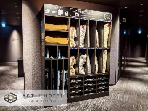 a room with a closet filled with lots of shoes at Astil Hotel Juso Precious in Osaka