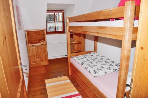 a small room with two bunk beds in it at Ferienwohnung Burgerhof in Pullenreuth