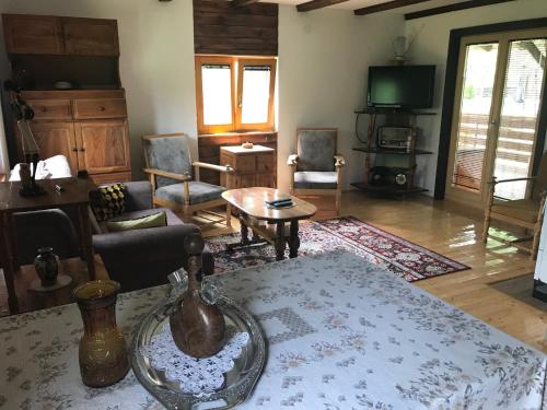 a living room with a table and chairs at Seosko domaćinstvo Bondžulić in Užice