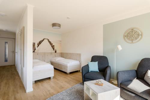 En eller flere senge i et værelse på Nordsee-Ferienwohnungen Hinrichsen
