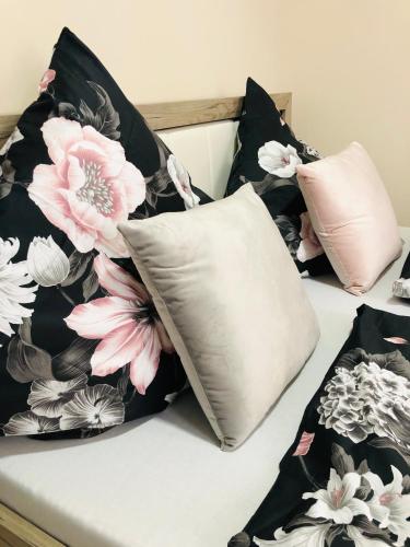 a bed with black and white pillows on it at Carla Maria S Hause in Gammertingen
