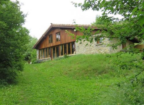 an old house on a hill with a green field at Chalet du bois d'Estève, baronnies provençales in Montjay