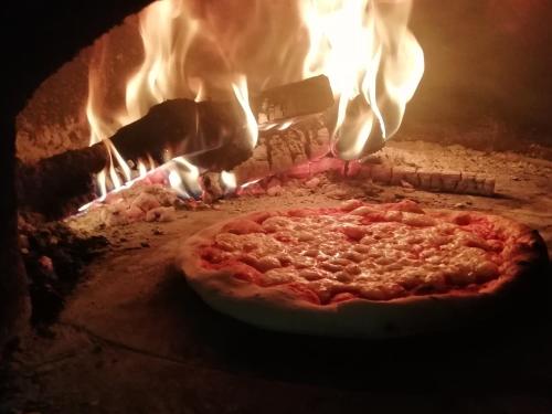 a pizza is being cooked in a brick oven at Gasthof Sterzingerhof in Vipiteno