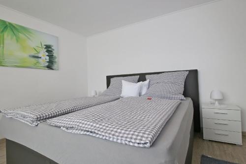 a bedroom with a bed with a checkered blanket at Ferienwohnung Wandl in Bad Griesbach