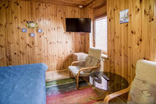 a living room with a couch and a table and a tv at Sea view apartments in Odesa