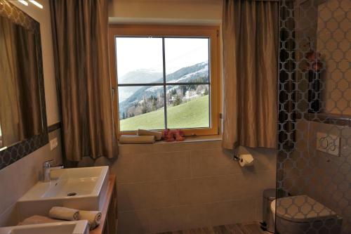 a bathroom with a sink and a window at Apartment Alpenstyle by Katharina in Zell am Ziller