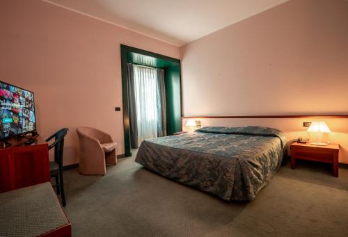 a hotel room with a bed and a television at Hotel Diana in Valdobbiadene
