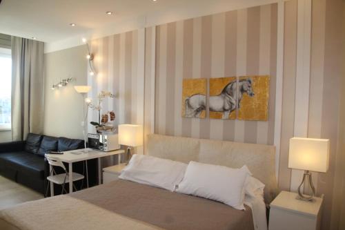 a bedroom with a white bed and white walls at B&B Pescara Centro Luxury Suite in Pescara