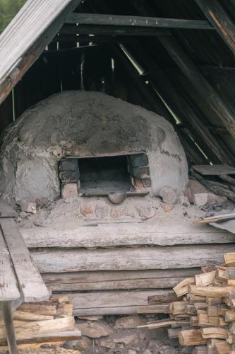 a large stone oven sitting inside of a building at Cabana Poiana Dealul Frumos in Gîrda de Sus