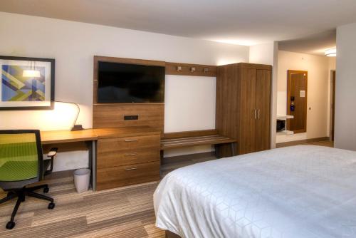 a hotel room with a bed and a desk and a television at Holiday Inn Express & Suites Omaha Downtown Old Market by IHG in Omaha
