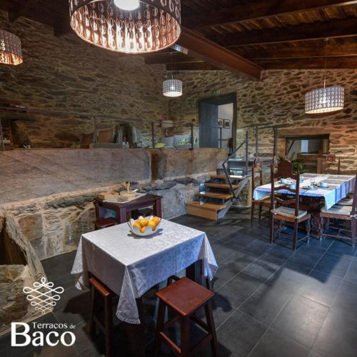 a room with a table and chairs in a building at Terraços de Baco in Ribalonga
