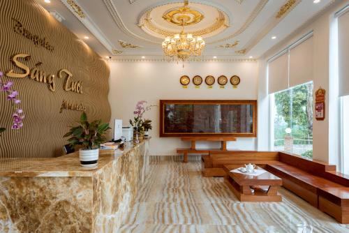 a lobby with a reception desk and a chandelier at Bungalow Sáng Tươi Mountains in Phu Quoc