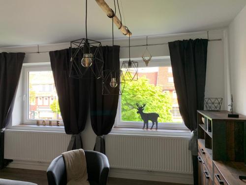 a room with a window with a deer in it at Harzstübl25 in Sankt Andreasberg