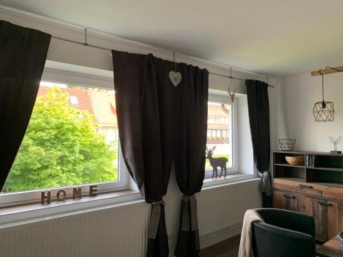 a window with black curtains in a room at Harzstübl25 in Sankt Andreasberg