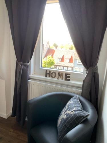 a blue chair sitting in front of a window at Harzstübl25 in Sankt Andreasberg