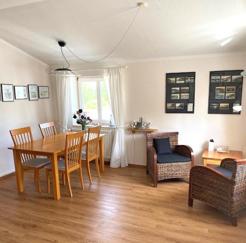 a dining room with a table and chairs at Meerblick Apartment in Göhren