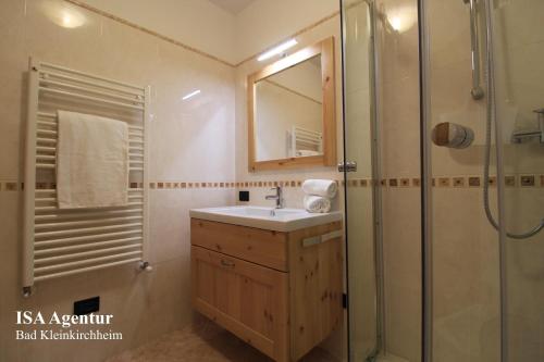 a bathroom with a sink and a shower at MAIBRUNN Apartment in Bad Kleinkirchheim
