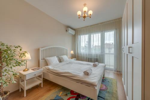 a small bedroom with a bed and a window at Beautiful Jewel in Top Center in Sofia