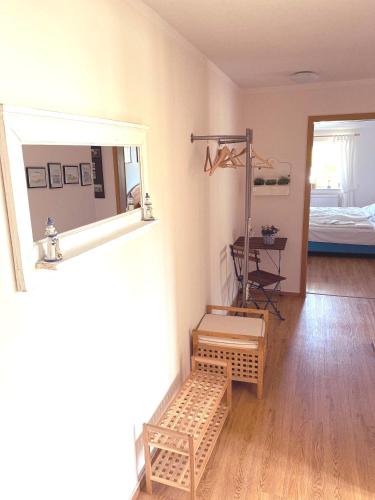 a room with a mirror and a table and a bed at Meerblick Apartment in Göhren