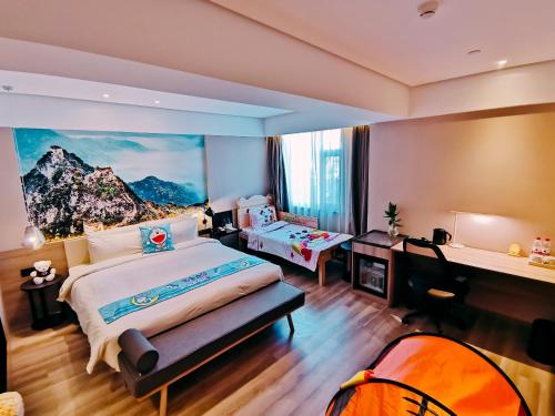 a bedroom with a large bed with a painting on the wall at Atour Hotel Langfang Xichang Road in Langfang