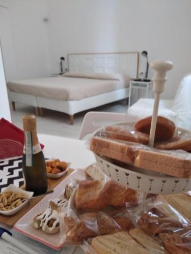 a table with a tray of donuts and a bed at La Chiave di Volta in Ragusa
