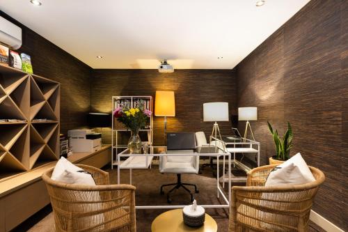 an office with wicker chairs and a desk at Living Hotel Lion's Eye in Cape Town