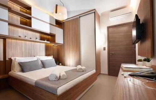 a bedroom with a bed with two towels on it at Armi Luxury Apartment in the Heart of the City in Chania Town