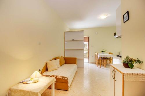 a living room with a couch and a table at Biserka apartments near the beach and center in Mali Lošinj