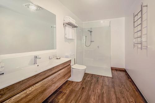 a bathroom with a sink and a toilet and a shower at Langsford Luxury in Stawell