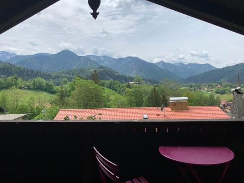 a view of a mountain range from a window at Dachgeschoss Ferienwohnung mit Charme - Top floor apartment with charme in Fischbachau