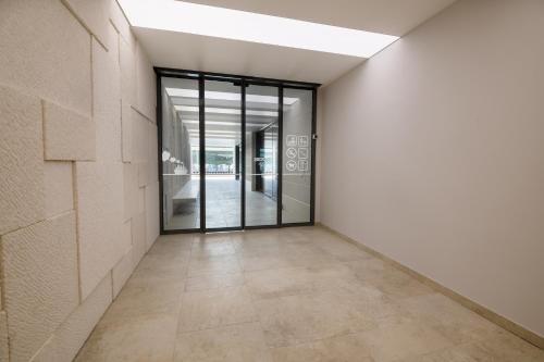 an empty hallway with glass doors in a building at Hotel VAPORE in Neum