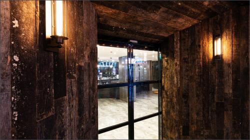 an open door to a room with a window at LALA VIANCO BUSINESS Hotel in Busan