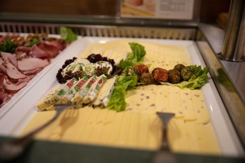 a plate of food with forks and vegetables on it at Landgasthof Goldener Pflug in Frasdorf