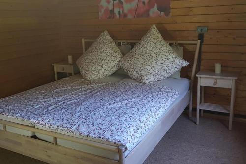 a bed with pillows on it in a room at Jagdhaus Malzhagen in Nümbrecht